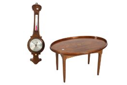A Victorian carved rosewood aneroid barometer and a later tray top table.