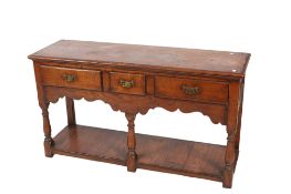 A reproduction oak pot board kitchen dresser base.