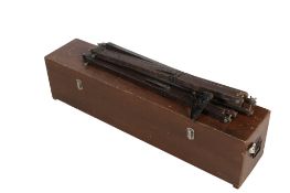 A 20th century cast metal telescope and a tripod.