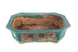 A large glazed terracotta planter.