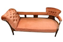A Victorian inlaid mahogany chaise lounge in peach upholstery.