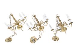 A set of three brass five light chandeliers.