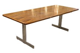 A modern mahogany rectangular meeting table. Raised on a pair of chrome supports.