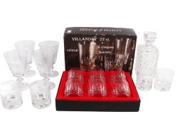 Three sets of glasses and a decanter.