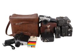 A collection of assorted vintage cine film cameras.