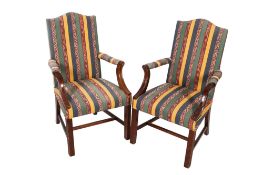 A pair of upholstered open armchairs.
