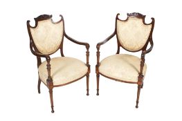 A pair of late Victorian mahogany and string inlaid salon chairs.