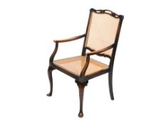 A mahogany framed open armchair. With cane work seat and back, cabriole front legs.