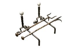 Two fire irons and a pair of fire dogs.