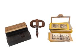 A collection of 19th century stereoview photographs and a wooden stereoscopic viewer.