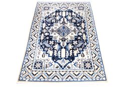 Contemporary cream ground wool rug with blue design.