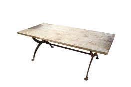 A rectangular dining table raised on a metal cross frame.