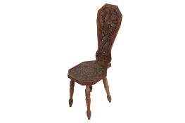 A carved oak spinning chair with leaf and berry design.