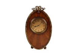 A French 20th century walnut marquetry and brass mounted oval mantel clock.