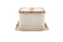 A continental gilt porcelain box with cover and stand.