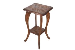 A small hardwood Chinese side table. Carved with lotus flowers to the top and splayed legs.