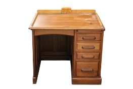 A 20th century stained pine single pedestal desk. Bank of graduated drawers to the right hand side.
