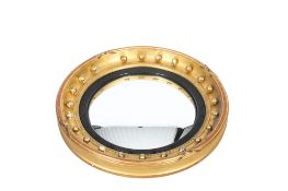 A 20th century convex wall mirror.