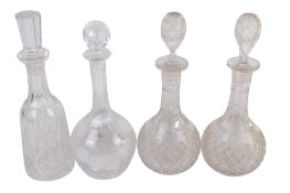Four assorted cut glass decanters. With stoppers. Max.