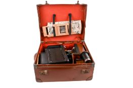 An Ensign Optiscope No 6 'magic lantern' glass slides projector and fitted case. With slides, etc.
