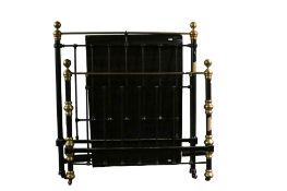 A vintage brass and painted metal double bedframe.