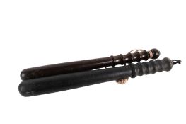 Two vintage wooden truncheons. Both having grip handles, largest L42.