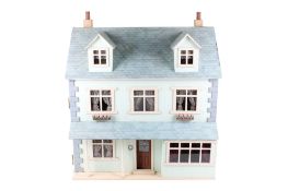 A modern wooden doll's house and contents.