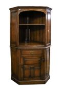 A large 19th century style oak corner cupboard.