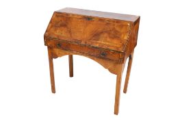 An early 18th century walnut veneered bureau top on a later stand.