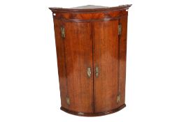 A Victorian mahogany and oak veneered corner cabinet.