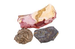 Two natural stones and a small bronze lion's head.