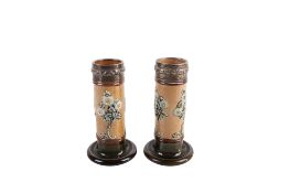 Pair of early 20th century Royal Doulton cylindrical spill vases with silver hallmarked collars.