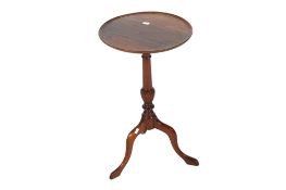 A mahogany wine table. Having a turned fluted pedestal on a tripod base.