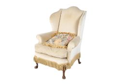 A Victorian arched wingback armchair. Raised on carved cabriole front supports. H108cm.