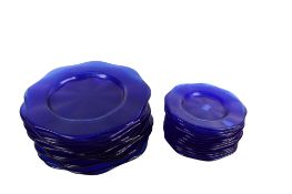Twenty-four cobalt blue glass plates.