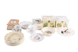 A collection of assorted Beatrix Potter books and related porcelains.