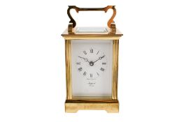 A mid-century brass carriage clock. Rapport, London, having five glasses, key present. H11.