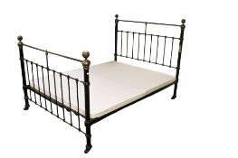 A vintage brass and painted metal double bedframe.