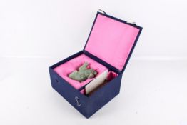 A 20th century Chinese green jade mythological lion carving. Reclining, with head raised, L12cm.