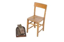 A vintage wooden schoolroom chair and a wine barrel sealer.