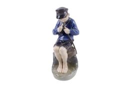 A Royal Copenhagen porcelain figure modelled as a boy whittler. No.