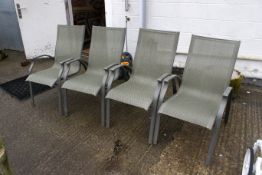 A set of four modern garden carver chairs. H94cm (63cm to armrests) W56cm D78cm. All items in this