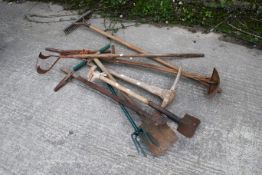 A collection of vintage handheld garden tools. To include a pick axe, a shovel, a spiker, a