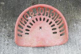 A red cast iron Nicholson tractor seat. Marked '1740' to the underside. W42cm D32cm. All items in