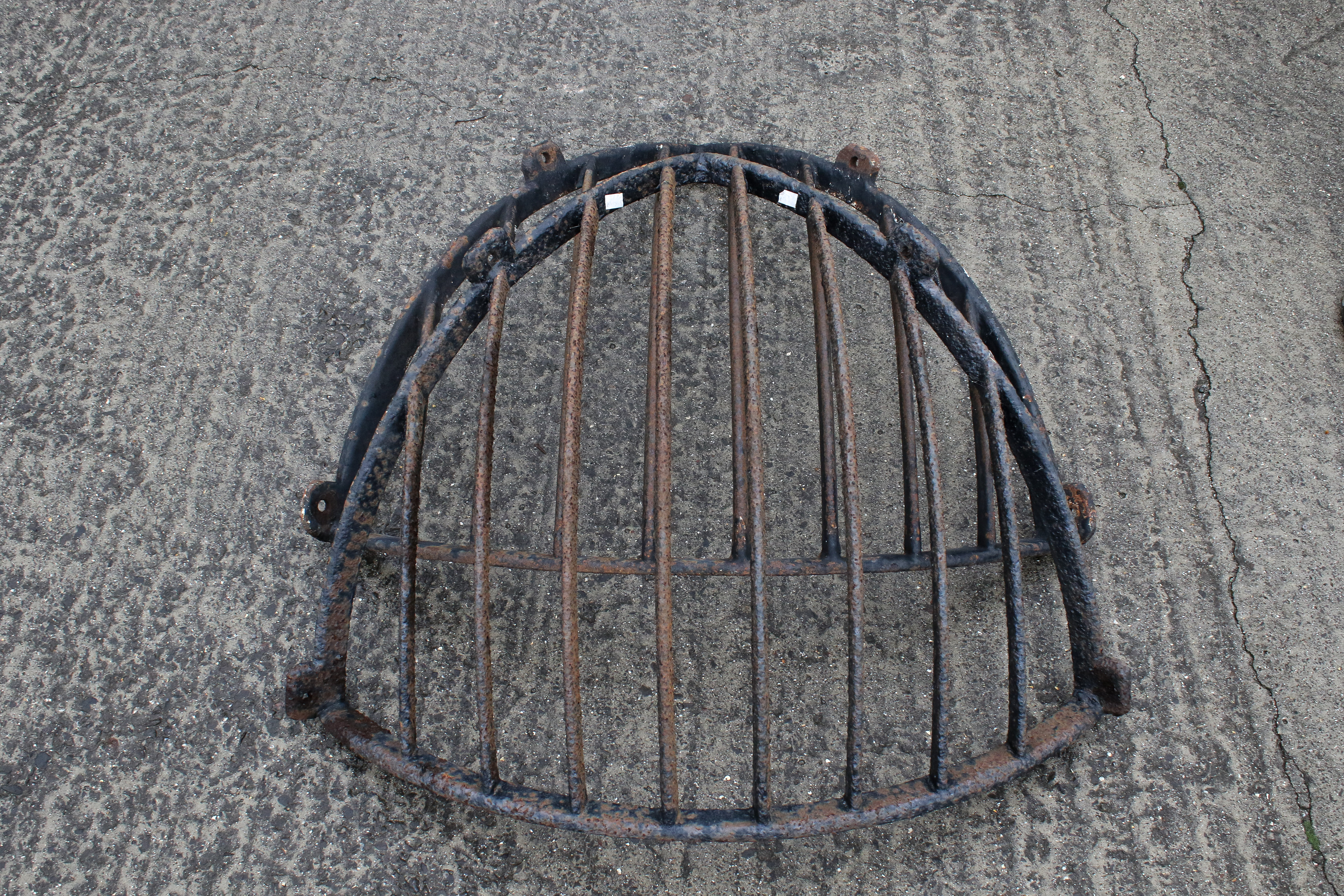A pair of wrought iron wall-mounted corner hay racks or feeders. H75cm W90cm approx. All items in