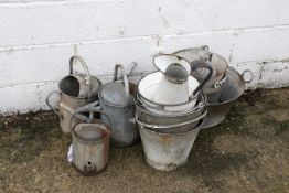 A collection of galvanised watering cans and buckets. Together with an enamel jug and bucket.