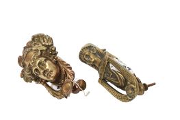 Two vintage cast brass door knockers. In the form of a classical mask and an Eygptian sphinx. Max.