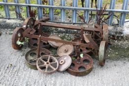 A group of assorted cast metal trolley wheels and pulley wheels. Max. diameter 30cm All items in