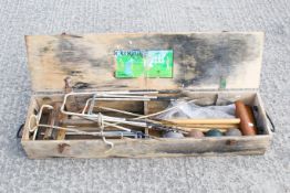 A lawn croquet set in a wooden case. Including four mallets, four balls and metal hoops. All items