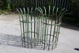 A pair of green painted iron strapwork crown top tree gaurds. H104cm & 110cm, C50cm. All items in